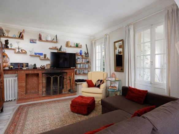 Interior of a villa in Cap d'Antibes with living room, fireplace and library.