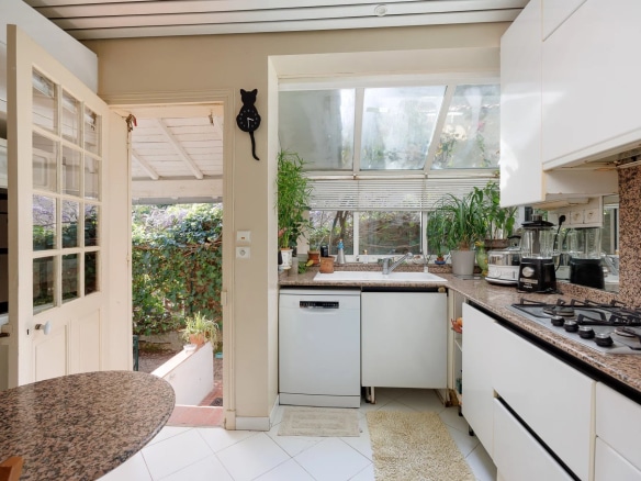 Kitchen of a villa in Cap d'Antibes with a view of the garden.
