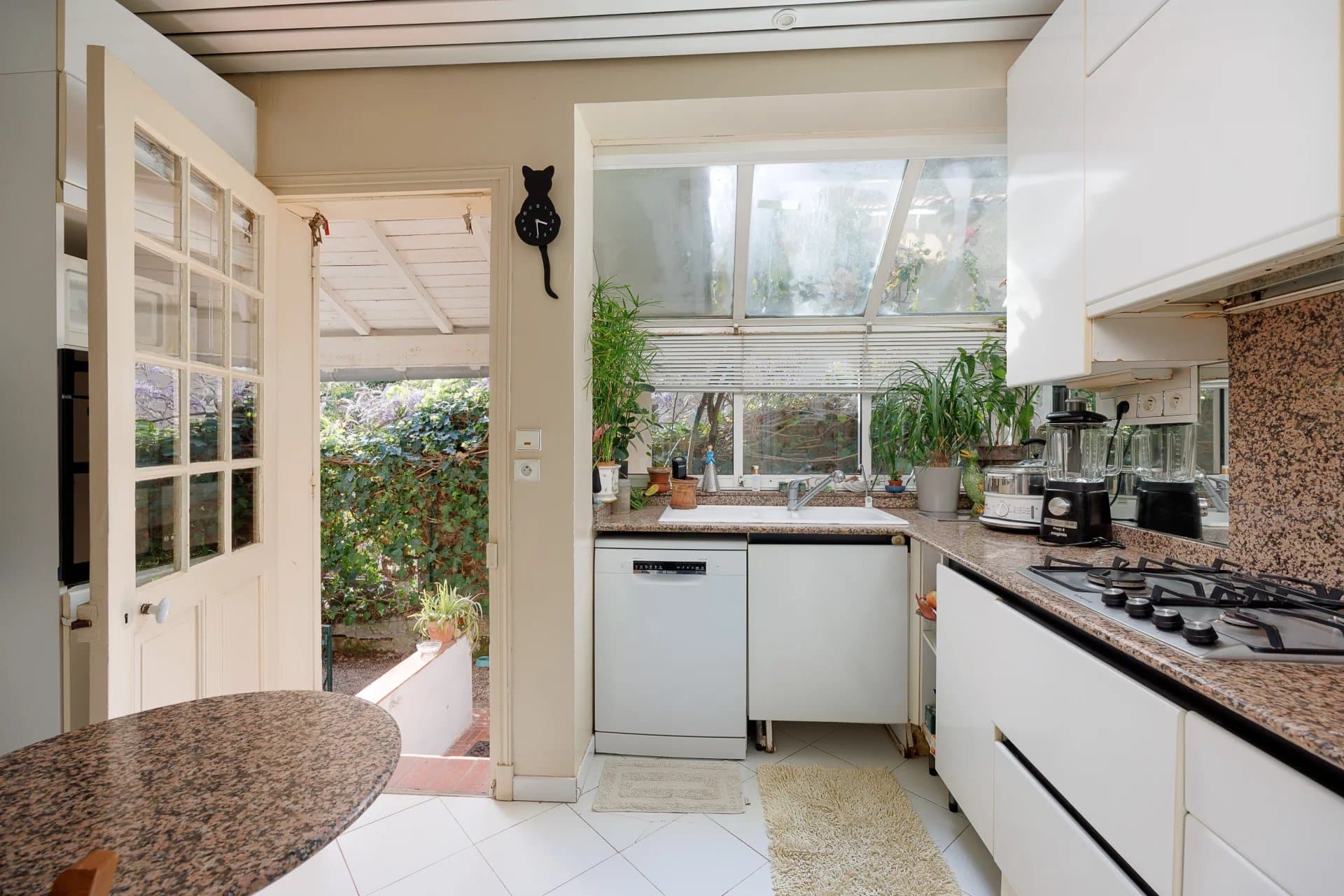 Kitchen of a villa in Cap d'Antibes with a view of the garden.