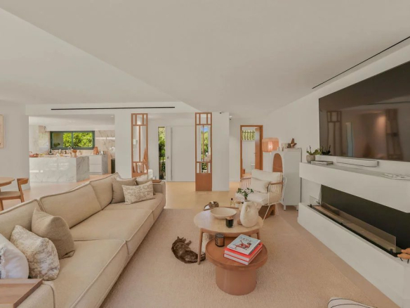 Interior of a modern villa with a bright living room, fireplace and contemporary decor.