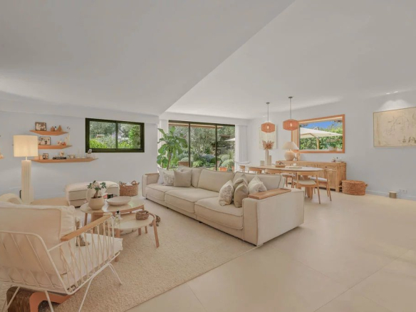 Interior of a modern villa with a bright living room and dining room, tastefully decorated.