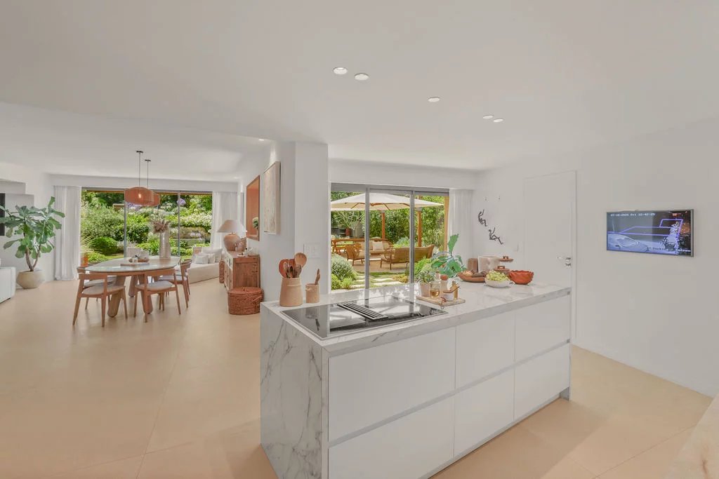 Interior of a contemporary villa Interior of a modern villa with an open-plan kitchen leading to a bright living room and access to the garden.