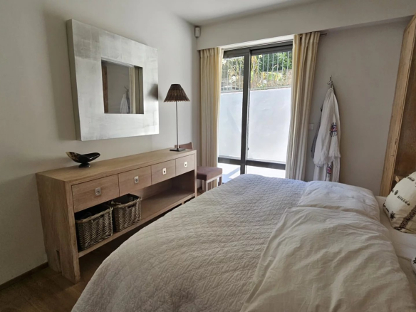 Room in a bright apartment with modern decor and access to an outdoor area.
