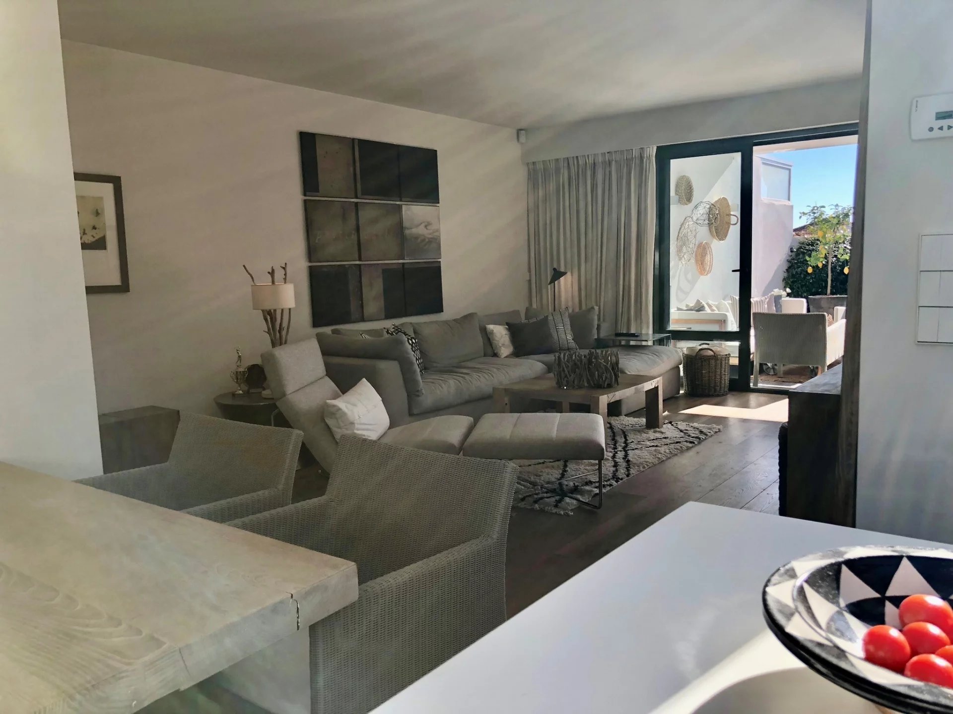 Bright apartment in Antibes Interior of a bright apartment with a modern living room and access to a terrace.