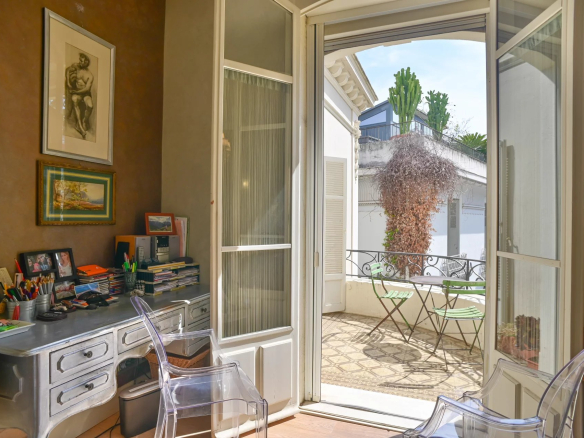 Interior of a Belle Époque apartment in Cannes with an office and a terrace.
