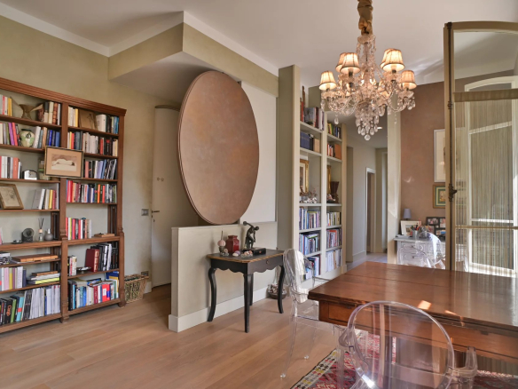 Interior of a Belle Époque apartment in Cannes, with library and chandelier.