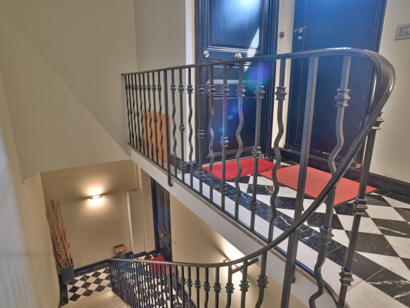 Spiral staircase with wrought iron railing in a Belle Époque building in Cannes.