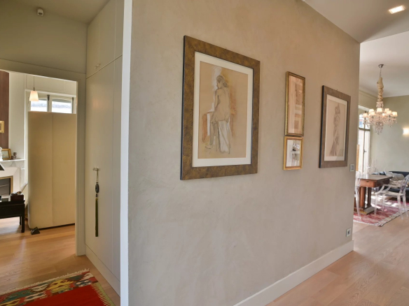Interior of a Belle Époque apartment in Cannes, with light walls and artwork on display.