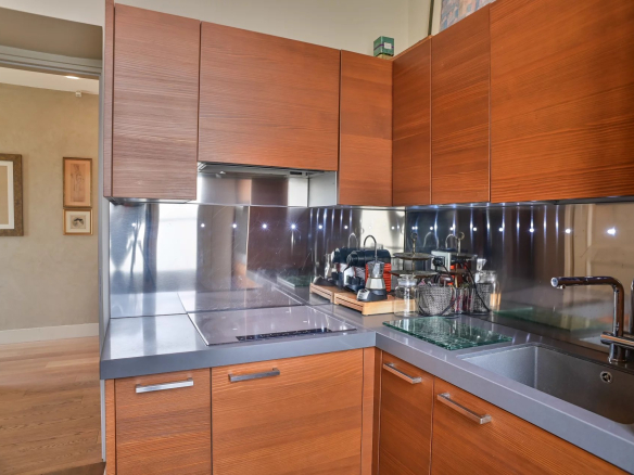 Modern wooden kitchen with contemporary appliances in a Belle Époque apartment in Cannes.