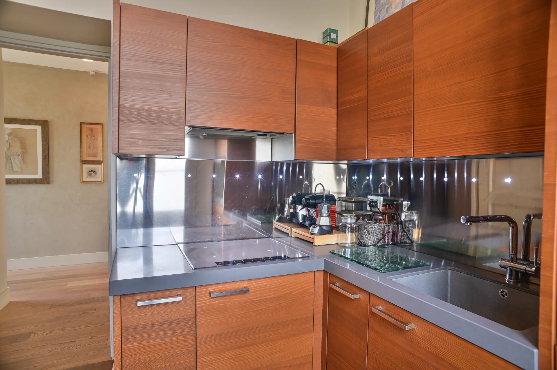 Kitchen of a Belle Époque apartment in Cannes Modern wooden kitchen with contemporary appliances in a Belle Époque apartment in Cannes.