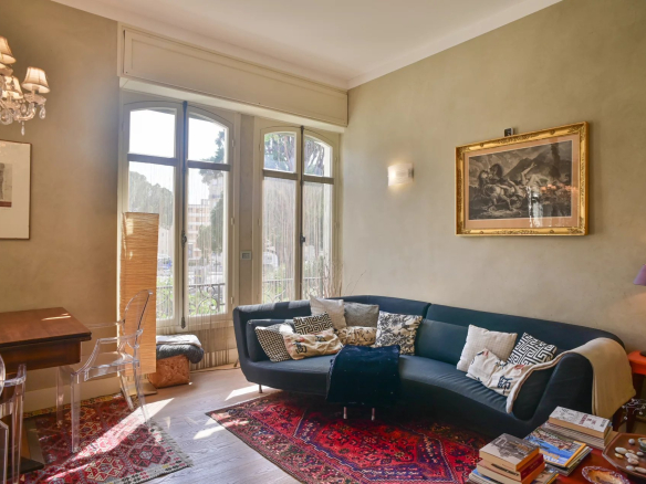 Living room of a Belle Époque apartment in Cannes, with modern sofa and elegant decor.