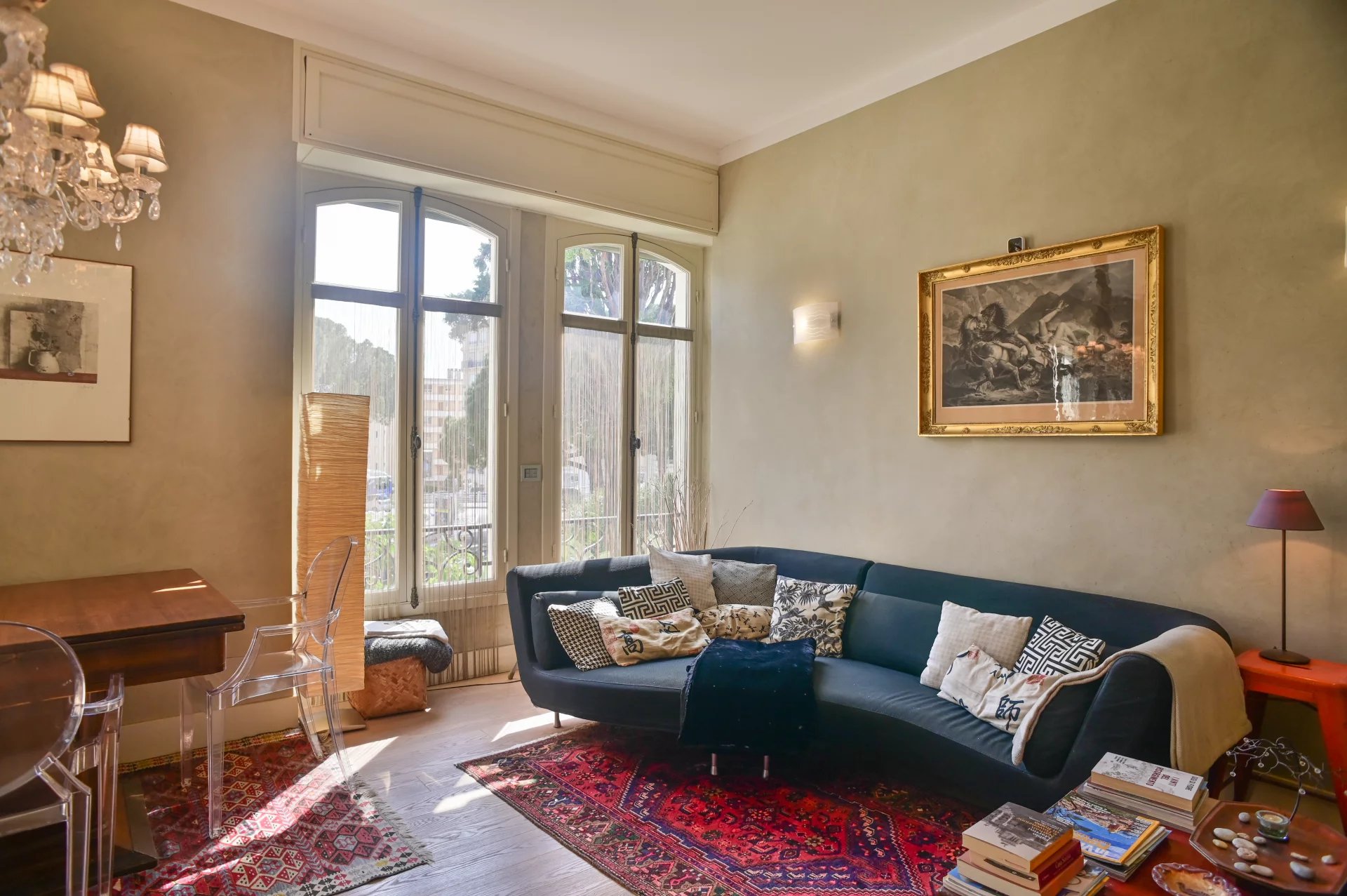 Living room of a Belle Époque apartment in Cannes Living room of a Belle Époque apartment in Cannes, with modern sofa and elegant decor.