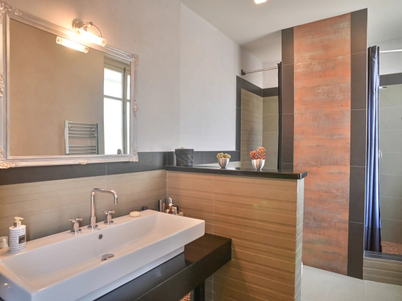 Modern bathroom with shower and sink in a Belle Époque apartment in Cannes.