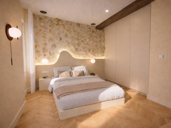 Chambre d'un appartement rénové avec lit double, murs décoratifs et éclairage doux.