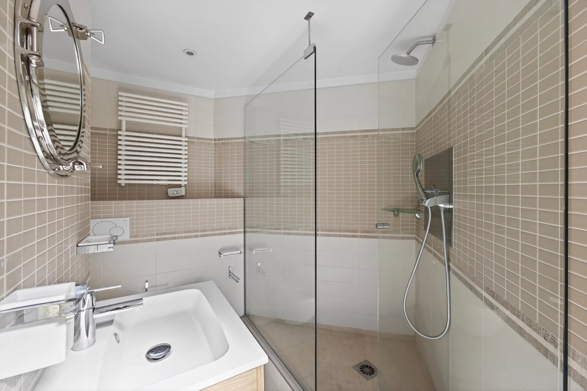 Bathroom of an apartment in Cap d'Antibes Modern bathroom with glass shower and sink.