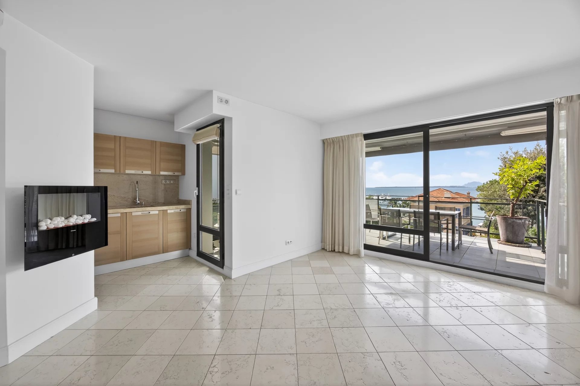 Modern apartment in Cap d'Antibes Interior of a modern apartment with open kitchen and access to a large terrace with sea views.