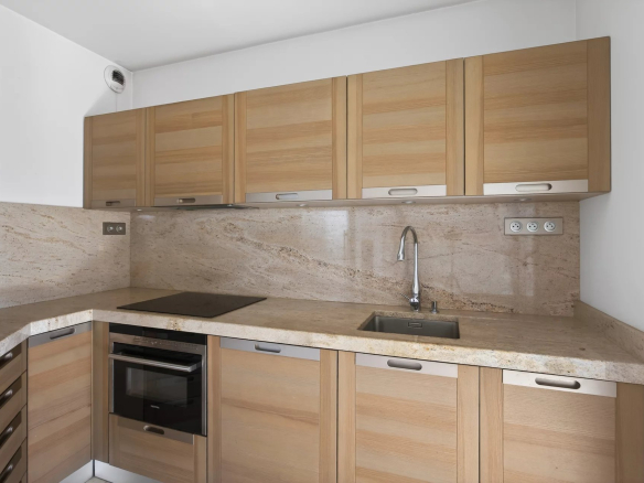 Modern wooden kitchen with marble worktops in an apartment in Antibes.