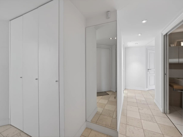 Interior of a modern apartment with an entrance hall and built-in closets.