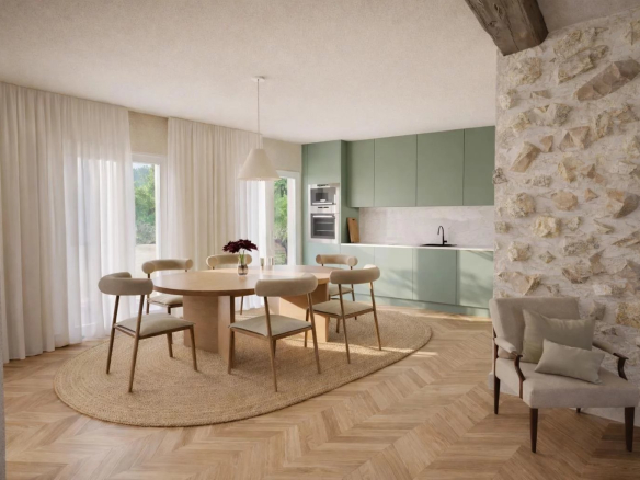 Intérieur d'un appartement rénové à Antibes, avec salle à manger, cuisine moderne et murs en pierres.