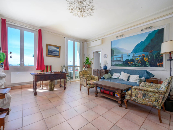 Interior of a 3-room apartment overlooking the Old Port of Cannes, traditional furniture and natural light.