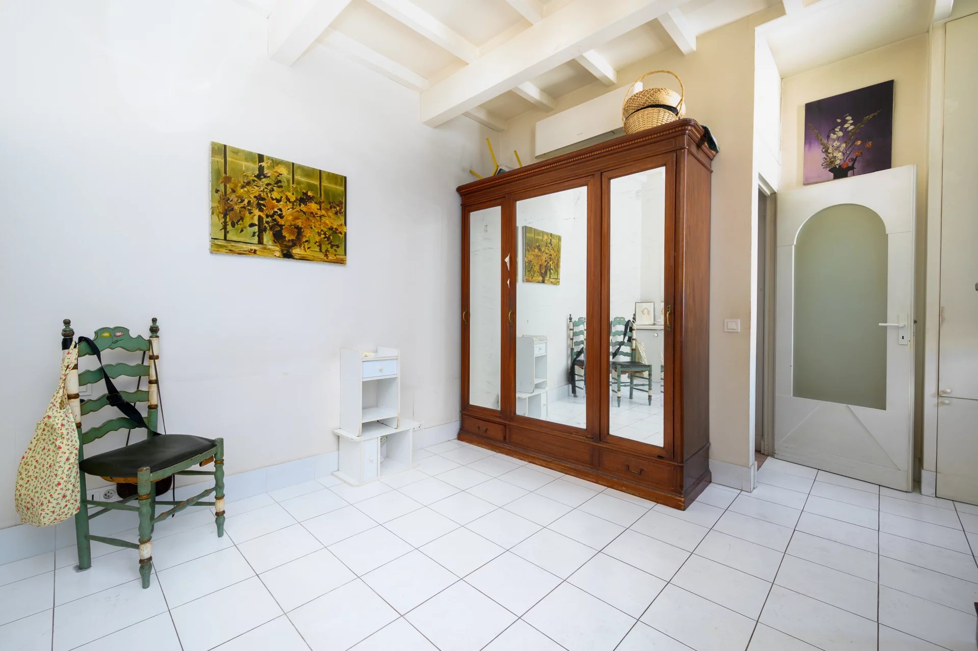 Interior of an apartment in Cannes Interior of a 3-room apartment in Cannes, with a mirror and colorful chairs.