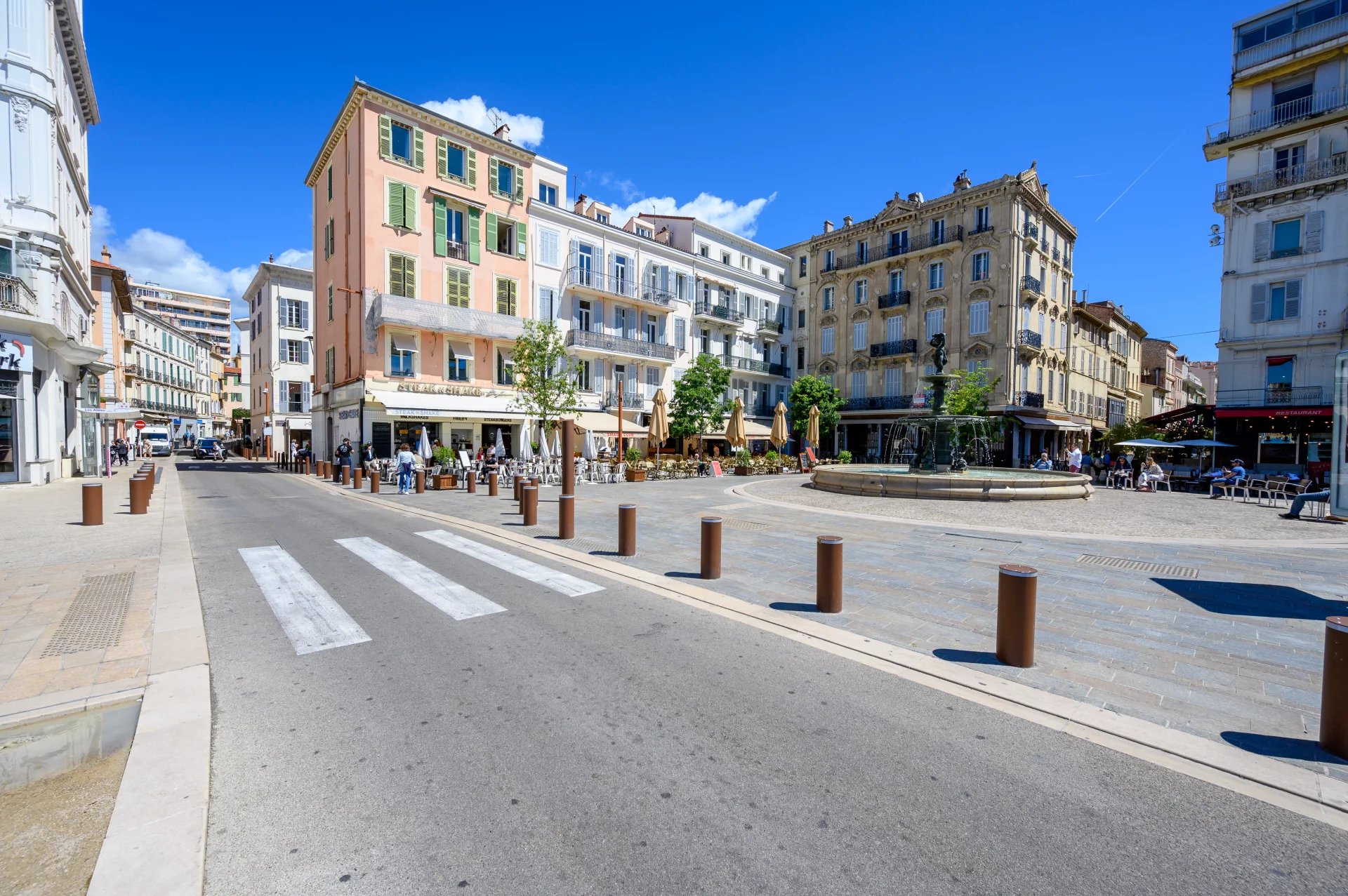 Old Port of Cannes View of the Old Port of Cannes with buildings and a lively square.