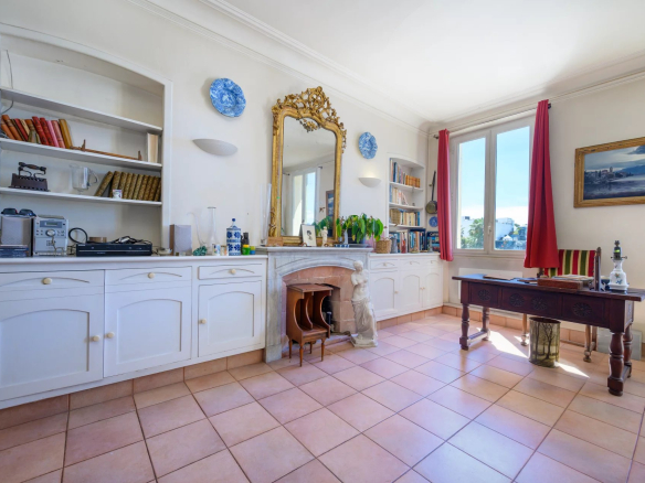 Interior of a 3-room apartment with classic furniture and a view of the Old Port of Cannes.