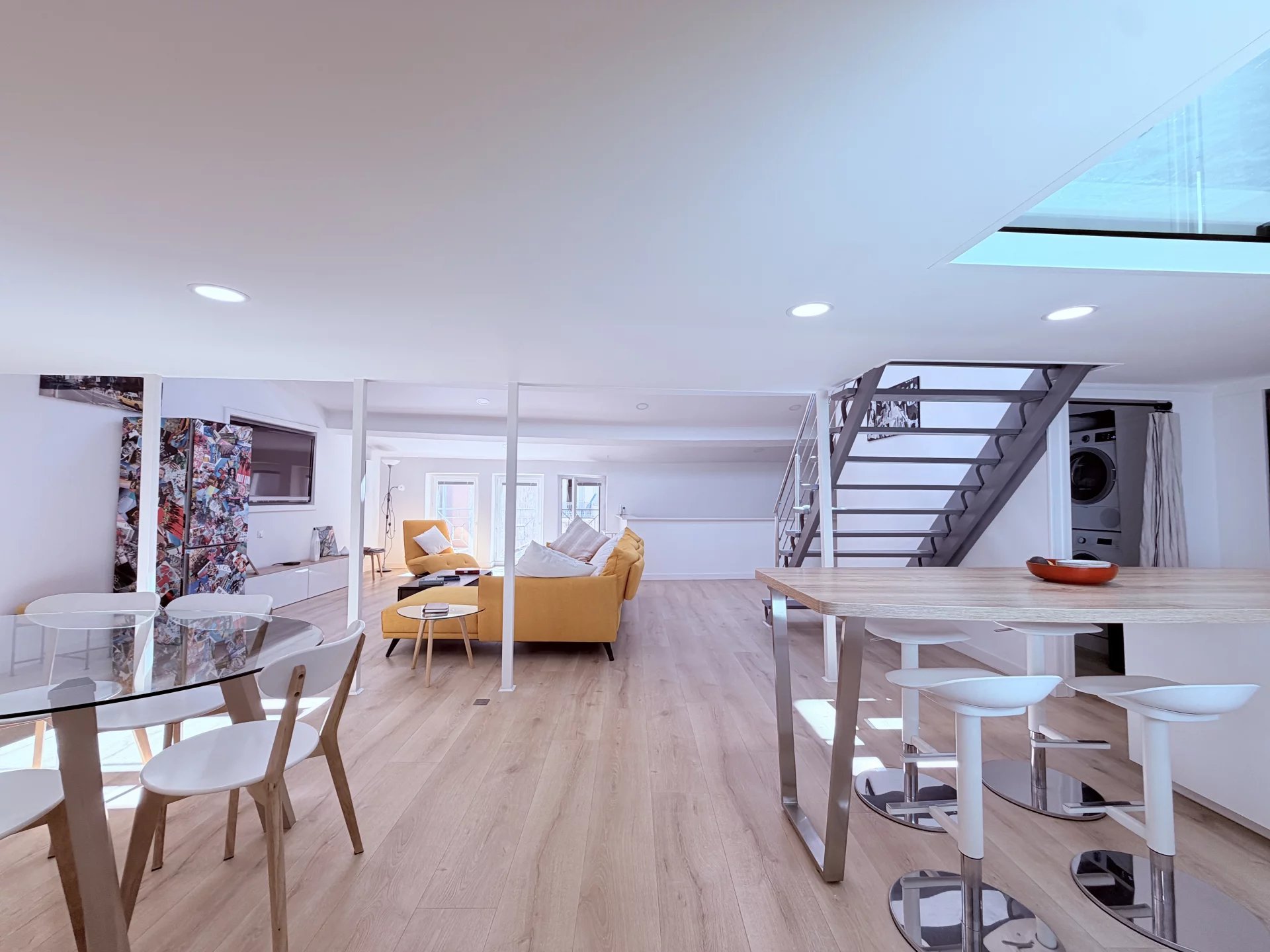 Loft under the eaves in Cannes Interior of a modern loft with living room, kitchen and staircase, located under the rooftops in Cannes.
