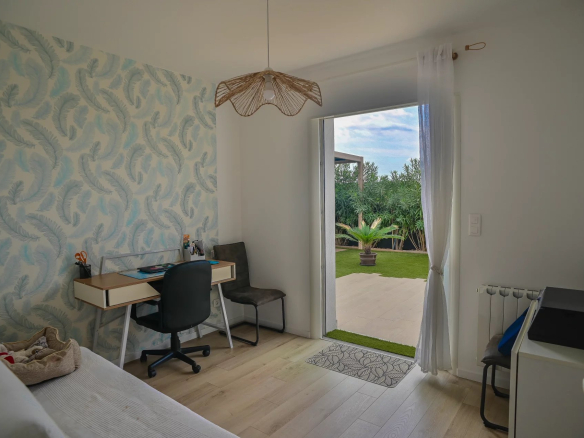 Room in a contemporary villa with access to the outside and modern decor.