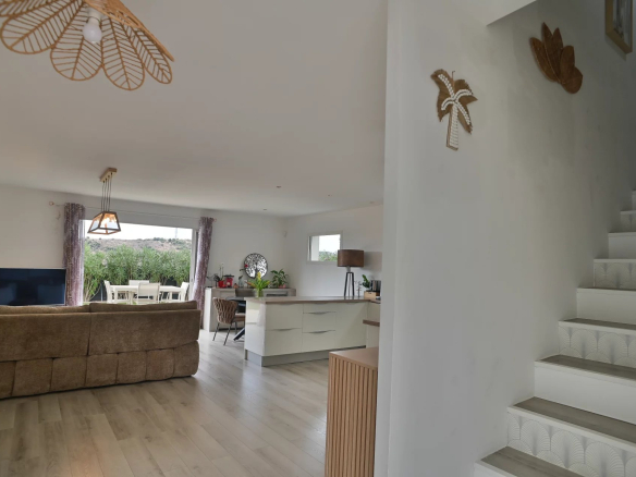 Interior of a contemporary villa with bright living room and staircase, Villeneuve-Loubet.