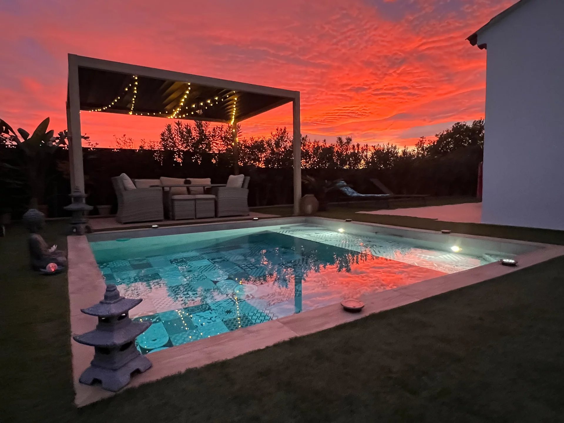 Contemporary villa with swimming pool in Villeneuve-Loubet Private swimming pool of a contemporary villa with a colorful sunset sky.