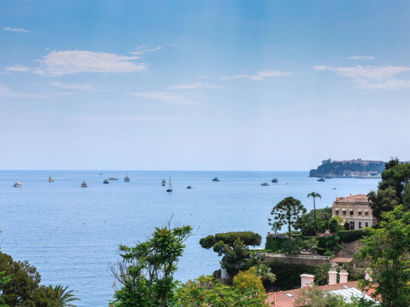 Panoramic sea view from an apartment in Roquebrune-Cap-Martin, with boats on the water.