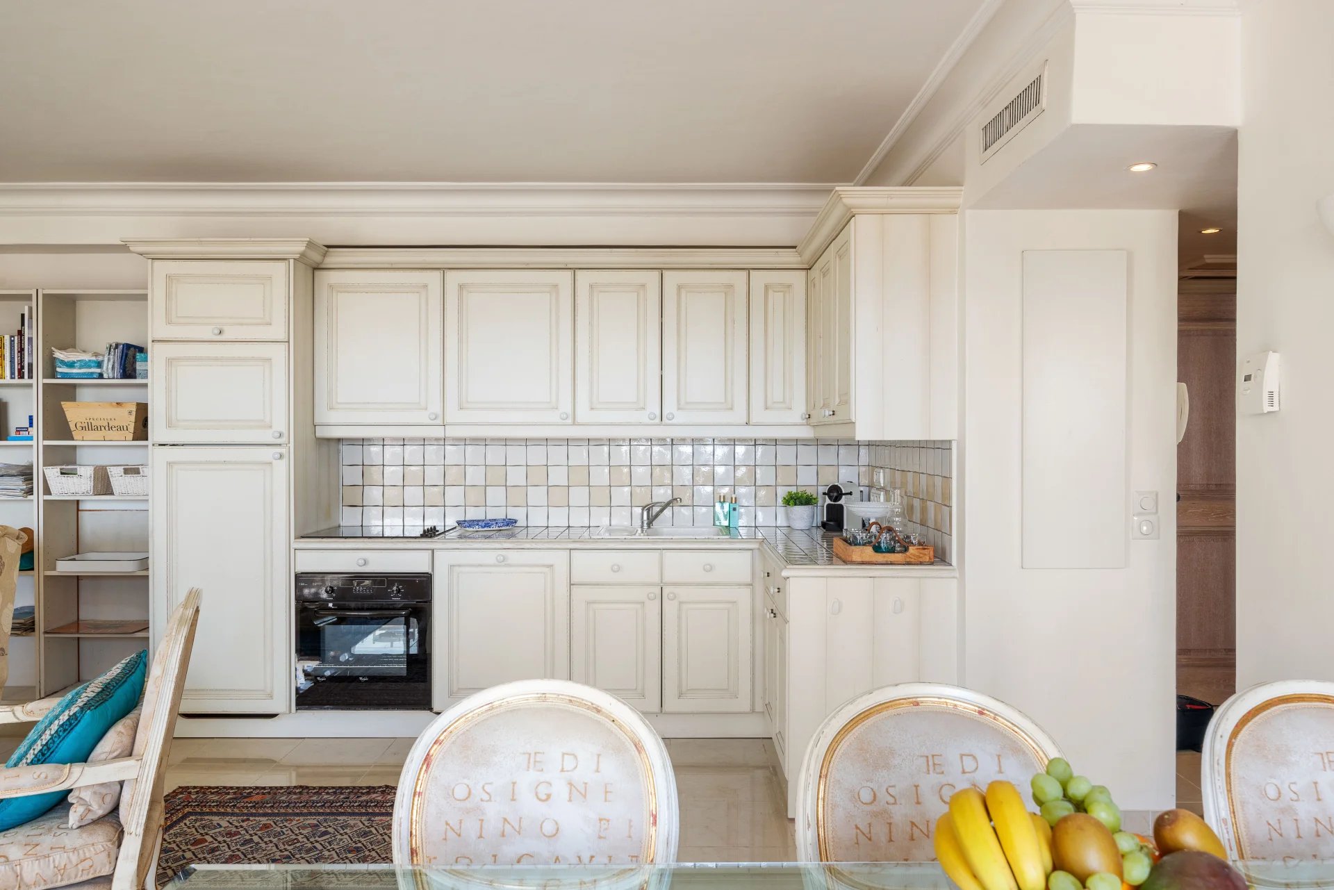 Cuisine moderne d'un appartement à Antibes avec meubles clairs et espace repas.
