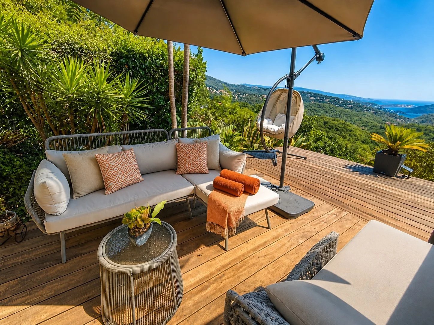 Wooden terrace with garden furniture and views of the hills and the sea in Les Adrets-de-l'Estérel.