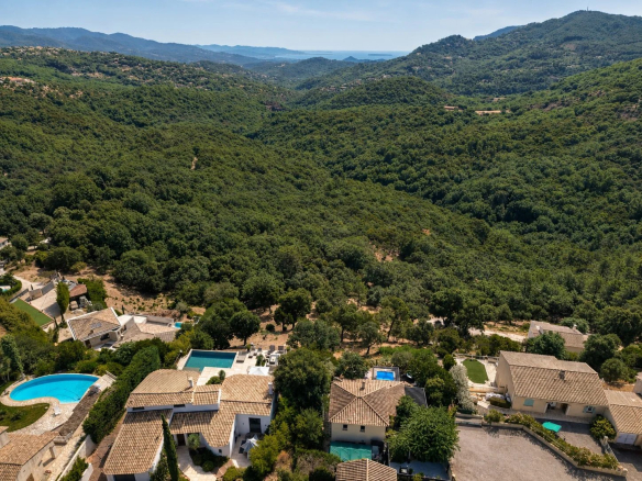 Aerial view of Les Adrets-de-l'Estérel with houses and green hills.