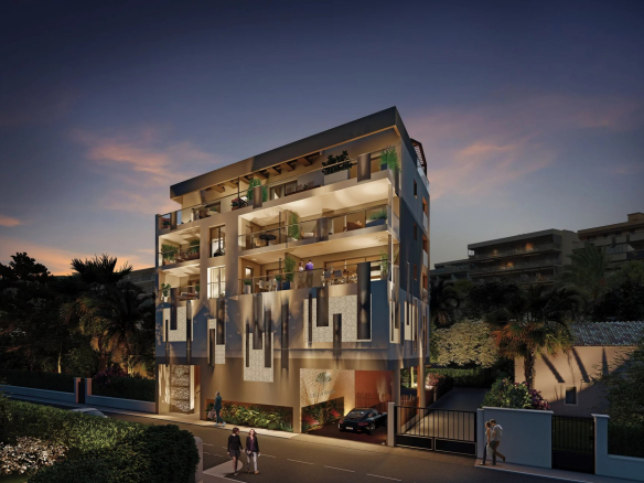 Immeuble moderne à Juan-les-Pins avec balcons et éclairage nocturne.