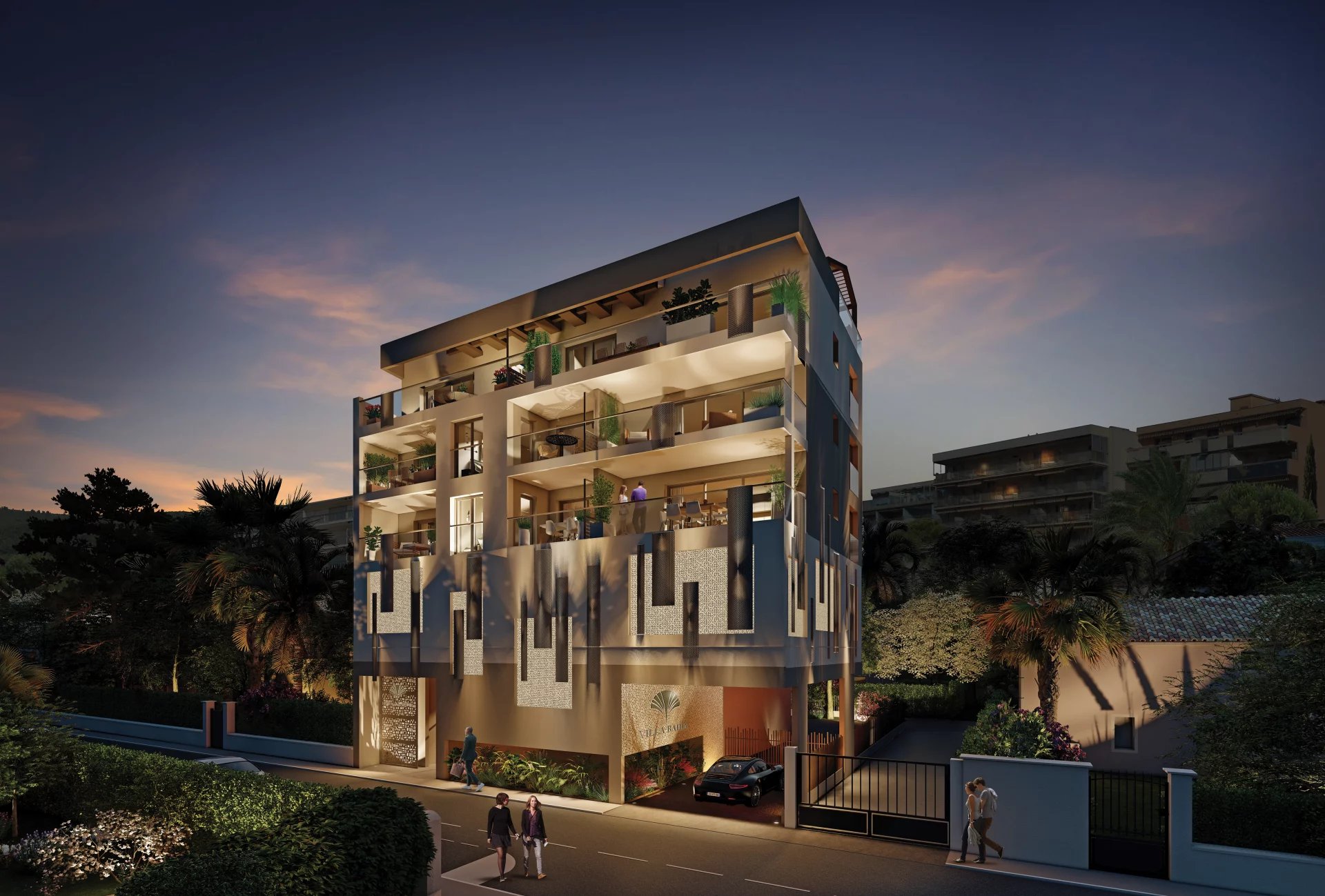 Résidence neuve à Juan-les-Pins Immeuble moderne à Juan-les-Pins avec balcons et éclairage nocturne.