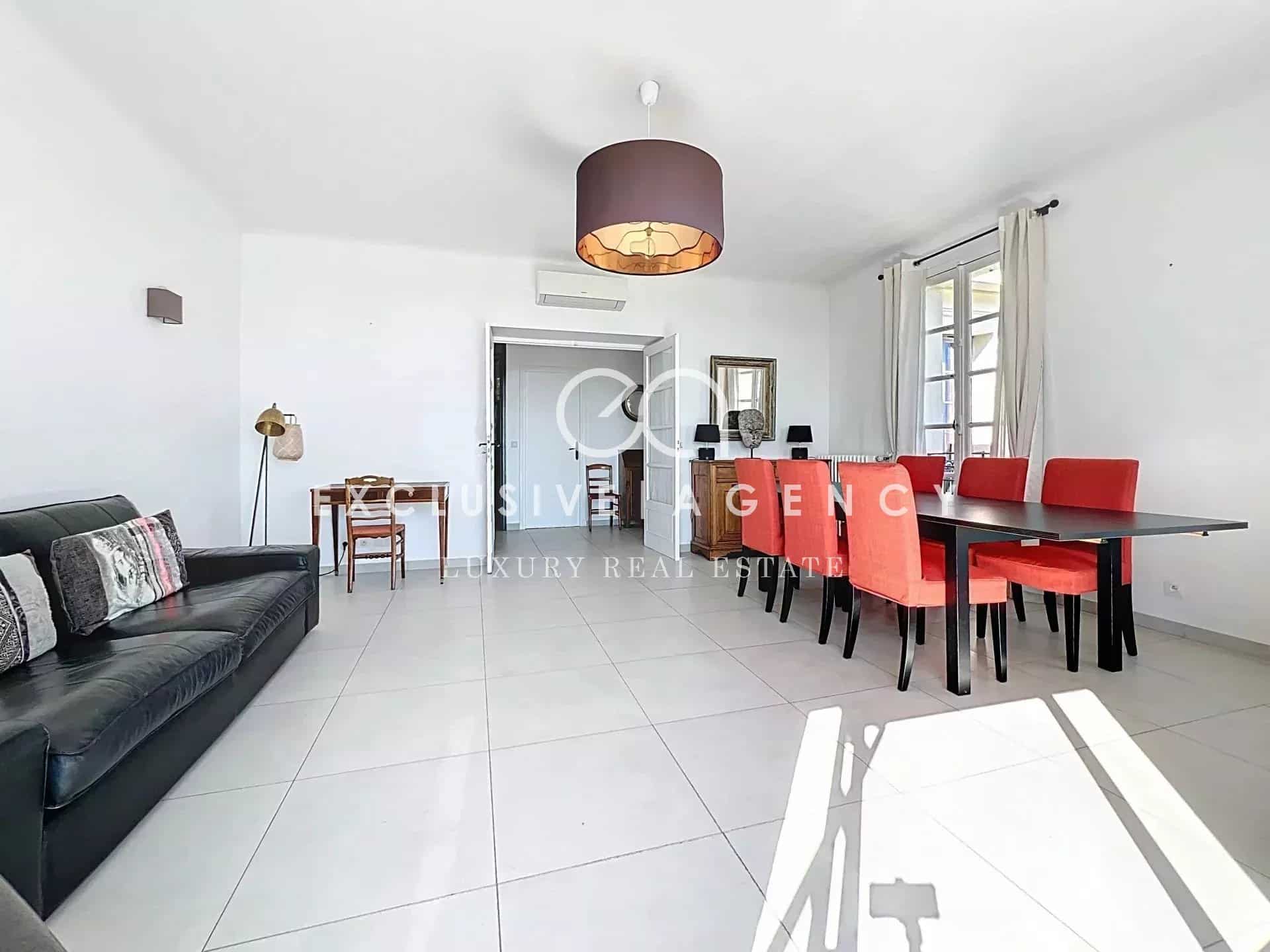 Interior of an apartment in Cannes with living room and dining room, modern and bright furniture.