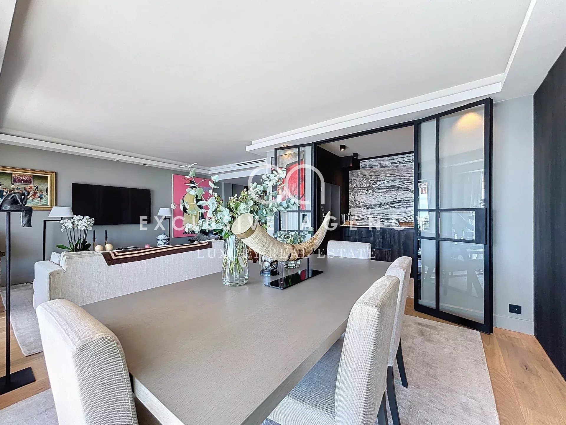 Interior of a modern 4-room apartment with sea view, elegant living room and dining room.