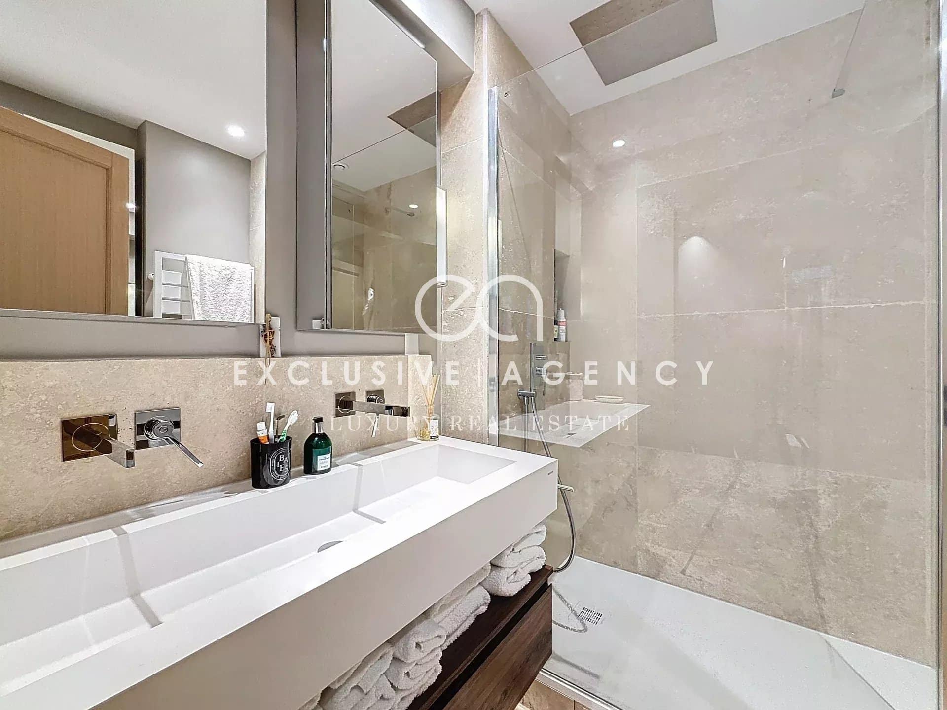 Modern bathroom with shower and sink in a renovated apartment in Cannes Eden.