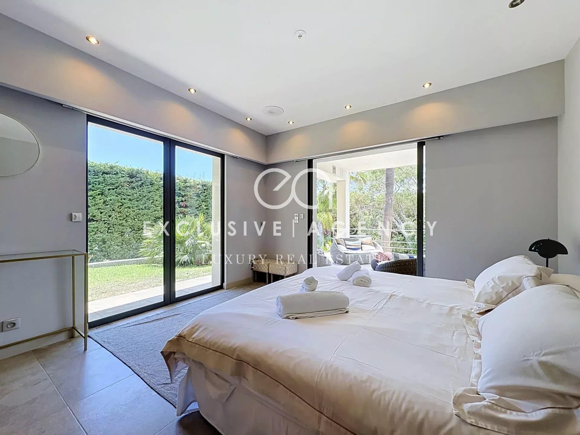 Chambre d'une villa californienne à Cannes avec accès à l'extérieur et vue sur le jardin.