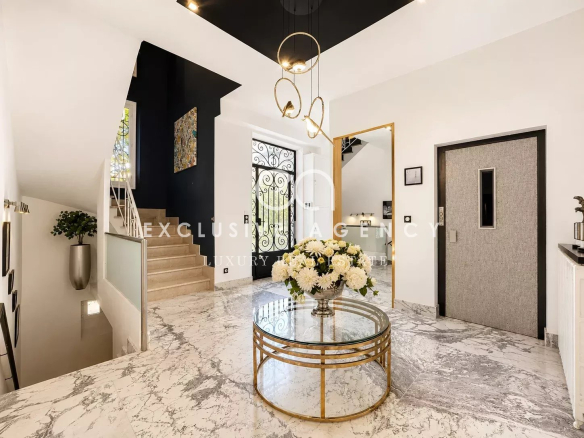 Interior of a renovated bourgeois house with an entrance hall and a marble floor.