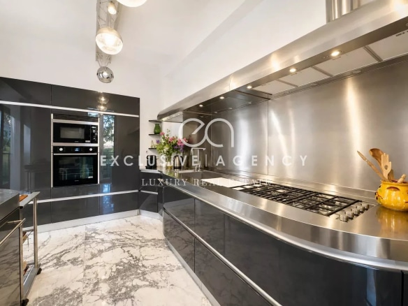 Modern kitchen with high-end appliances and a marble worktop.