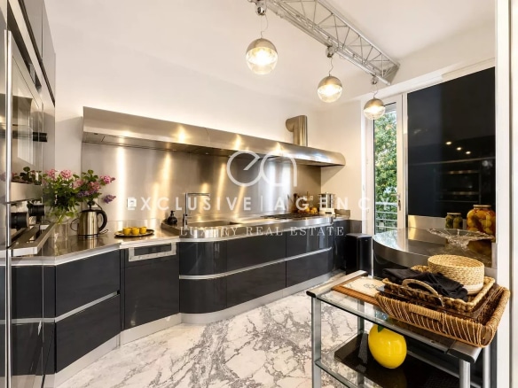 Modern kitchen with stainless steel appliances and a marble worktop.