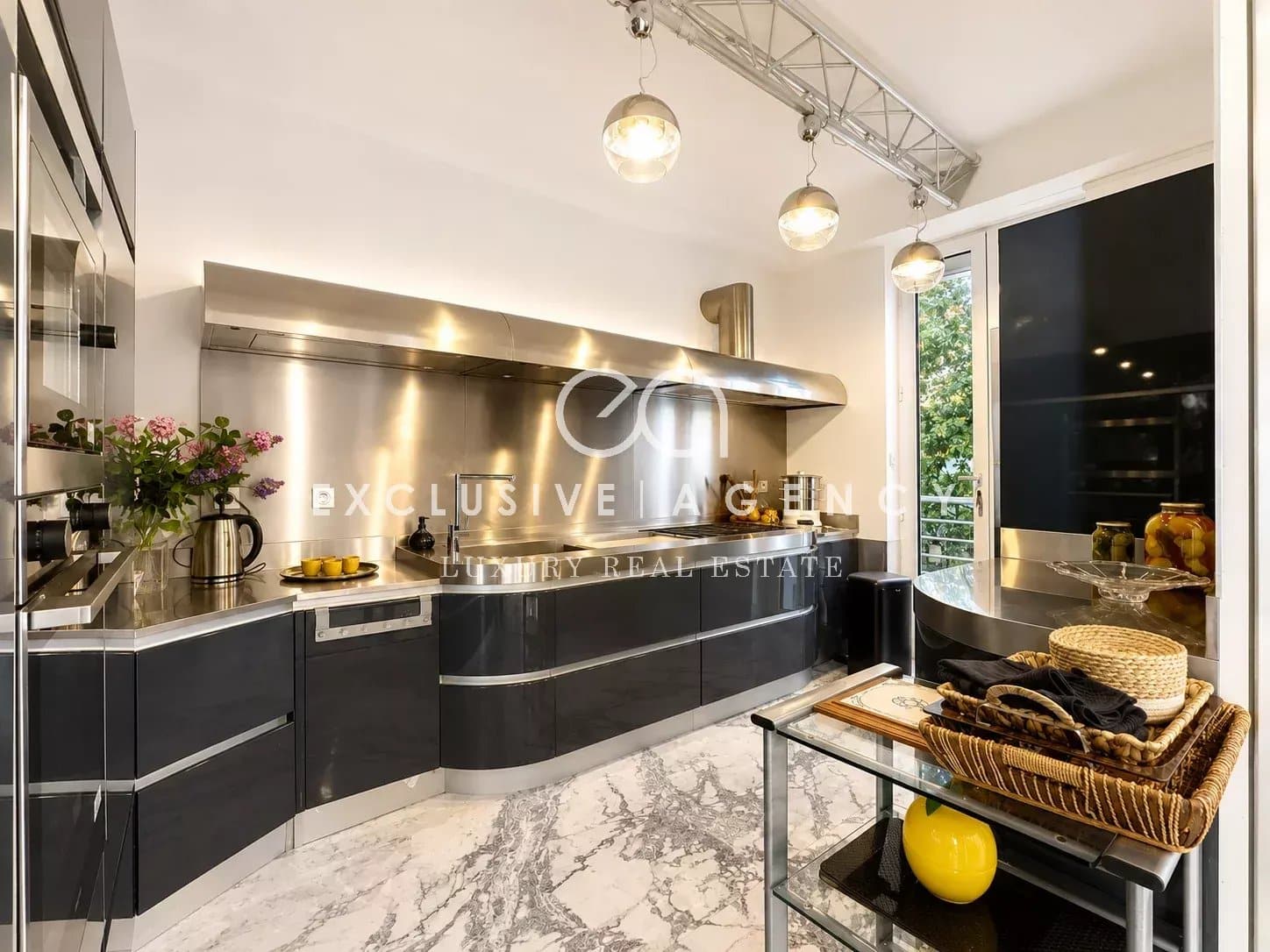 Elegant and contemporary kitchen Modern kitchen with stainless steel appliances and a marble worktop.