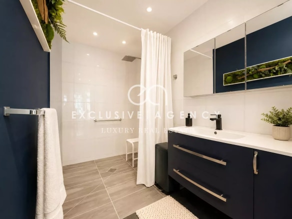Modern bathroom with shower, vanity unit and contemporary decor.
