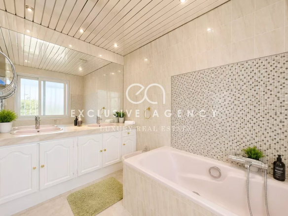 Elegant bathroom with bathtub and mirror, natural light