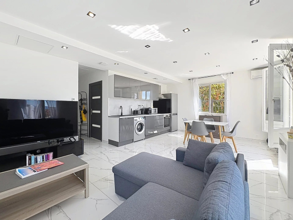 Interior of a family home in Cannes, with modern living room, fitted kitchen and dining room.