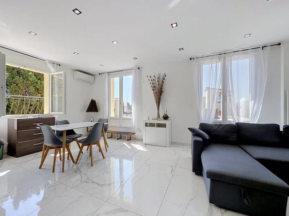 Bright interior of a living room with dining table and sofa, large windows.