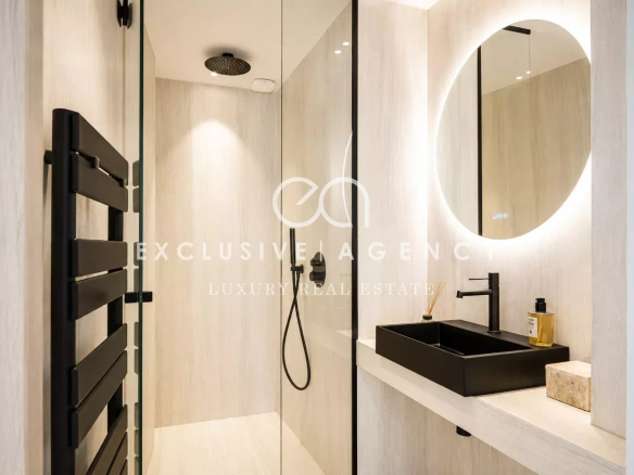 Salle de douche moderne avec douche à l'italienne et lavabo design.